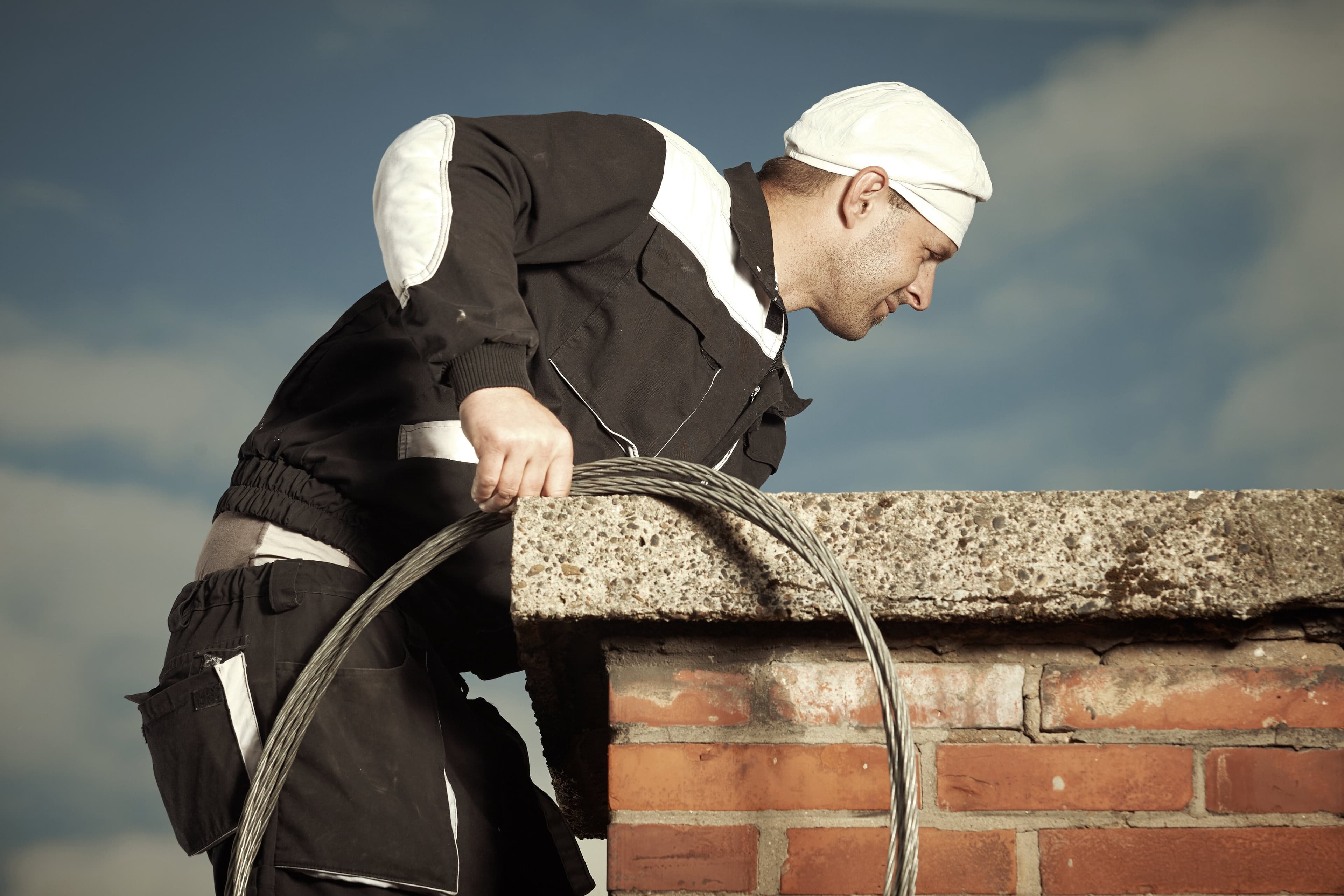 Chimney Sweepers at work, the trade Servgrow chimney sweeping software is built for